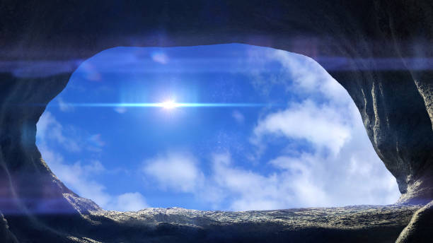 istock cave entrance, mysterious den opening with blue sky 1145478754