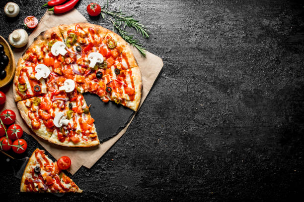 istock Fragrant sliced Mexican pizza with mushrooms and tomatoes. 1145478857