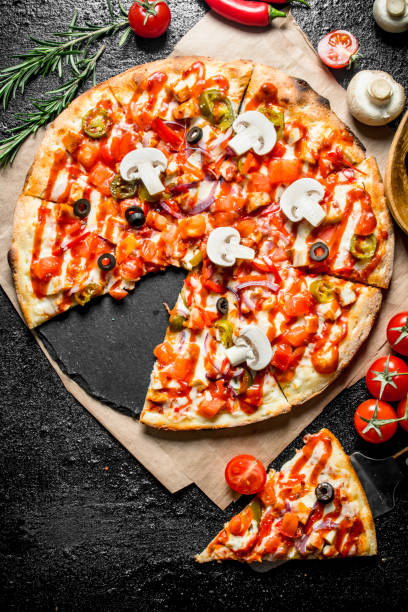 istock Fragrant sliced Mexican pizza with mushrooms and tomatoes. 1145478910