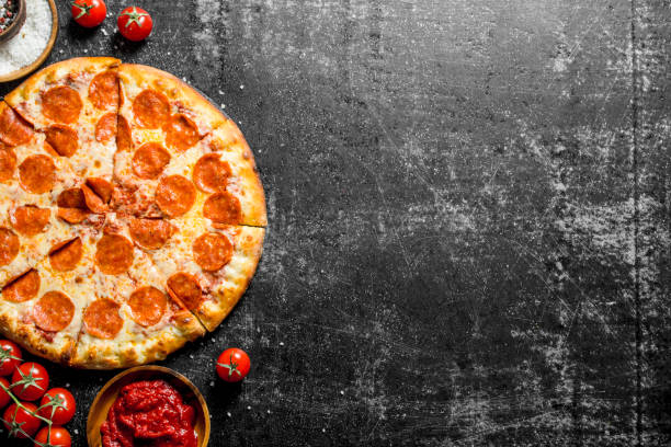 istock Pepperoni pizza with tomatoes, spices and tomato paste. 1145479012