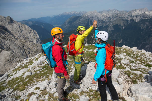 istock Three mountaineers celebrating on the top 1145483158