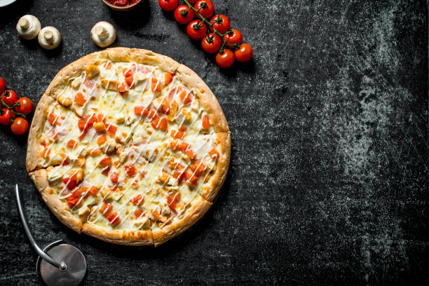istock Pizza with tomatoes, chicken and cheese. 1145483265