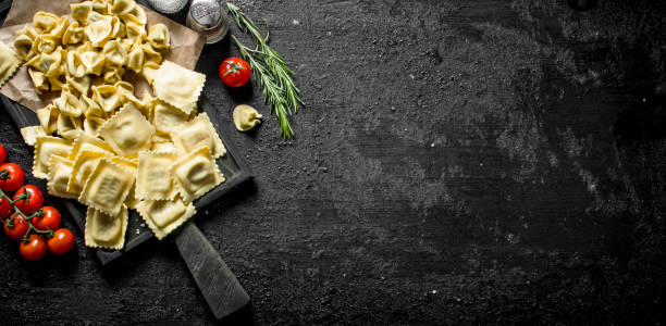 istock Ravioli and Dumpling raw with meat on the chopping Board. 1145483312