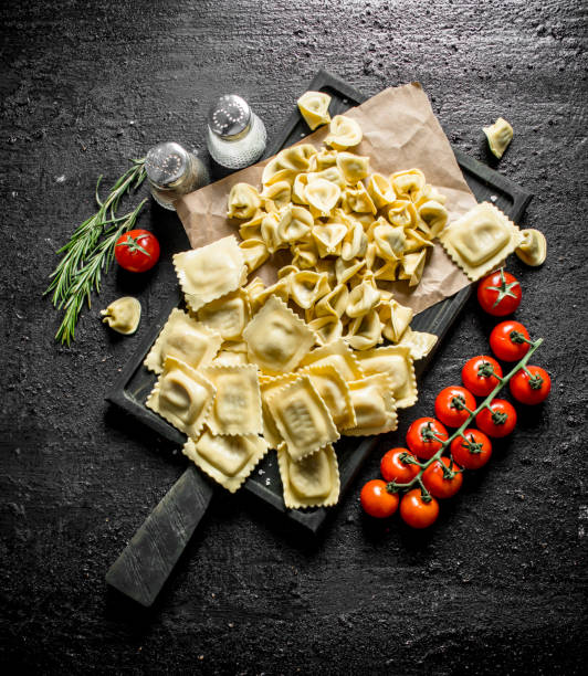 istock Ravioli and Dumpling raw with tomatoes, rosemary and spices. 1145483989