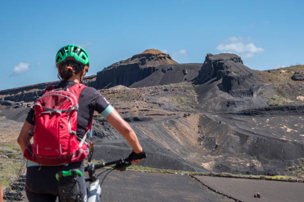 istock woman mountain biking on Lanzarote 1145485472