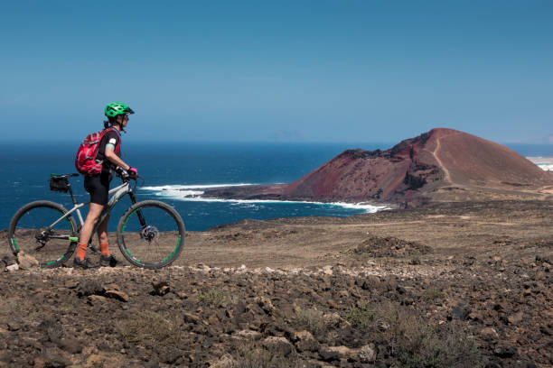 istock woman mountain biking on Lanzarote 1145485647