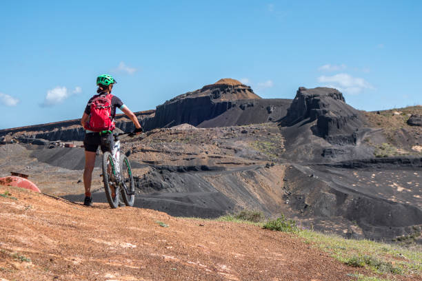 istock woman mountain biking on Lanzarote 1145486501