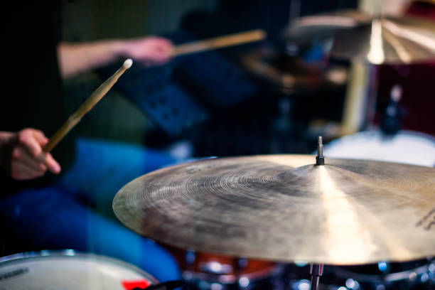 istock Professional drum set closeup. Man drummer with drumsticks playing drums and cymbals 1145488447