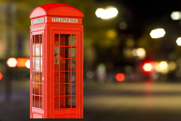 istock Red telephone box on the night street blurred background. 3D rendering 1145490448