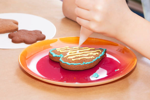 Decorating gingerbread cookies with icing, preparations for the holiday.