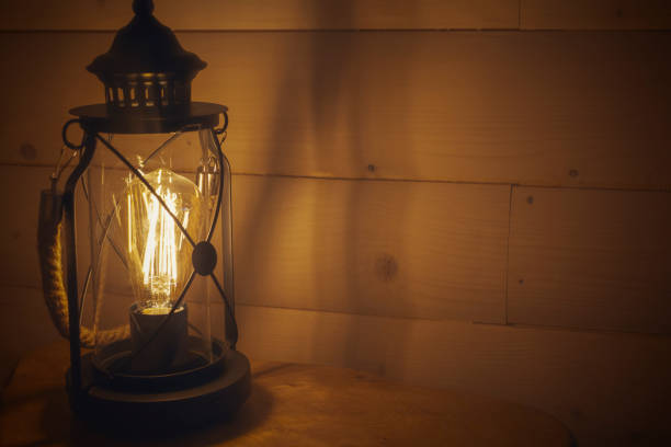 istock Old lantern hanging on a wooden wall 1145490621