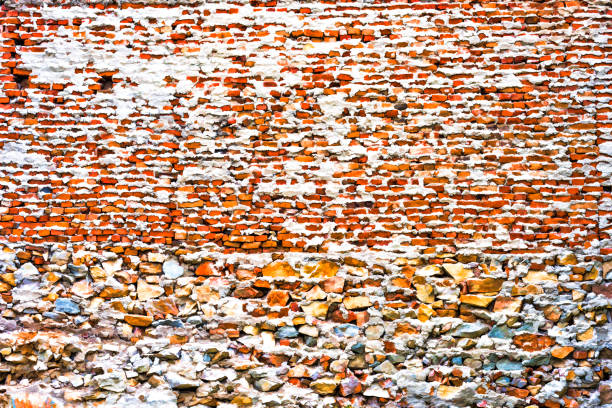 Background of brick wall texture -orange bricks single and stones with massive masonry.