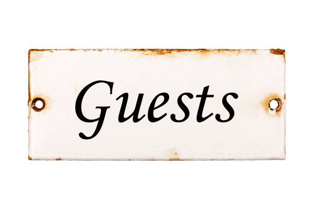 Guests, old and rusty enameled door plate, isolated on white background