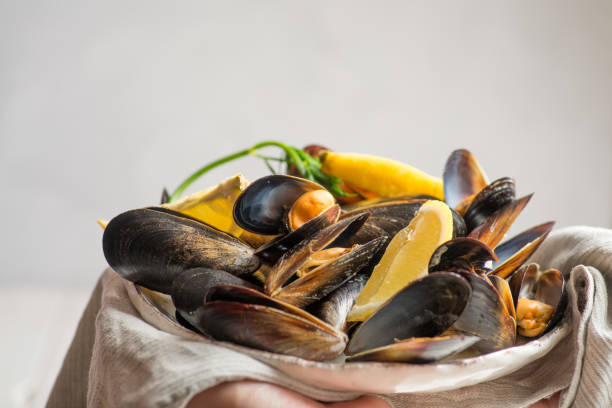 istock cooked mussels in the shells on the plate with lemon 1145495253
