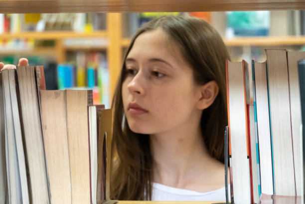 istock Young female student in the school library 1145497125