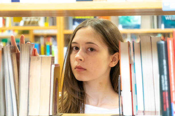 istock Young female student in the school library 1145497186