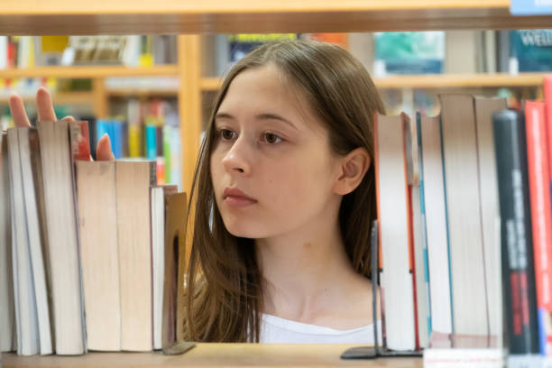 istock Young female student in the school library 1145497244