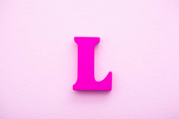 istock Wooden letter L on pink background. 1145497597