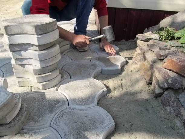 istock A man hammers paving slabs in a dry sand-cement mix with a rubber mallet 1145499825