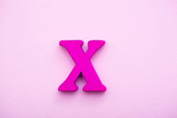 istock Wooden letter X on pink background. 1145501539