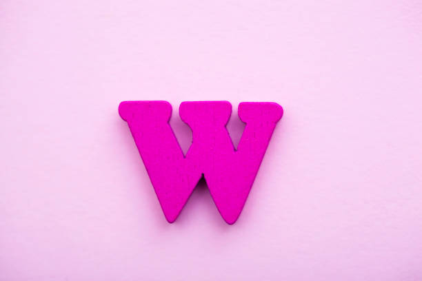 istock Wooden letter W on pink background. 1145501604