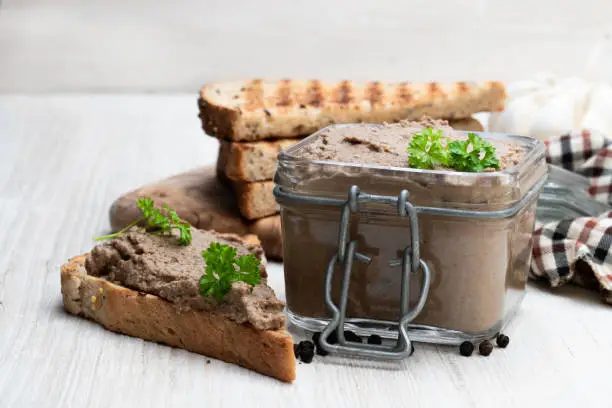 Fresh  pate with toasted bread on white table