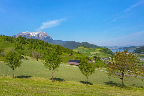A springtime view from the foot of Mt. Stanserhorn in the Swiss canton of Nidwalden near the town of Stans, summit of Mt. Pilatus in the background.