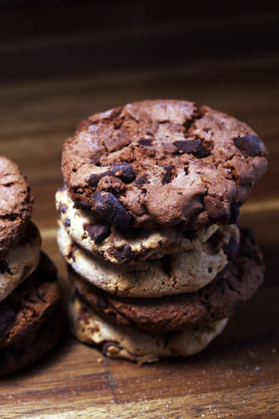 istock Chocolate cookies on wooden table. Chocolate chip cookies 1145505368