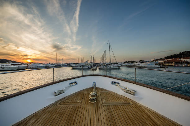 wide angle shot of front of the yacht in marina in sunset - yacht luxury front view ships bow imagens e fotografias de stock