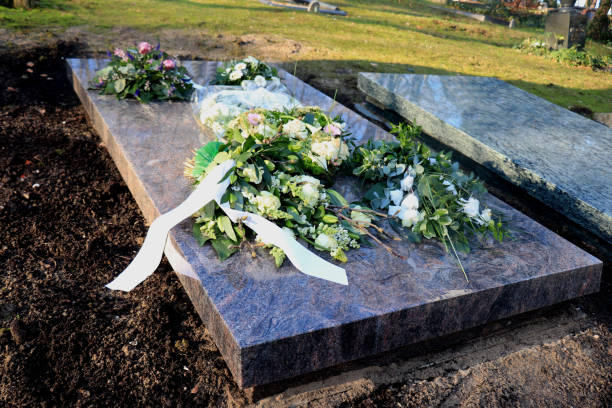 istock Sympathy flowers on a grave 1145512609