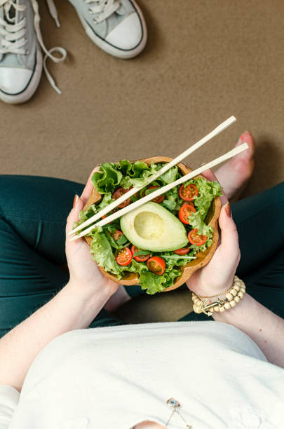 istock Girl and avocado salad 1145512695