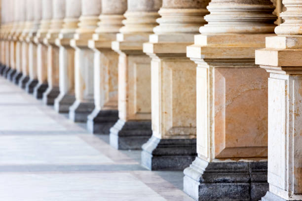 istock Colonnade, row of classical stone columns, background with copy spaced 1145513351