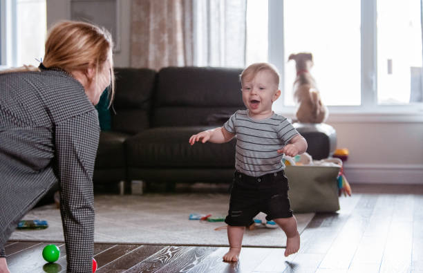 istock Parents Watching Baby Son Take First Steps At Home 1145514162