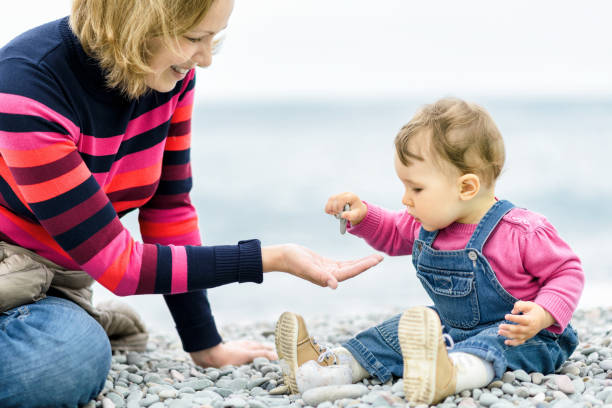 istock Baby with mother playing on the beach 1145518941