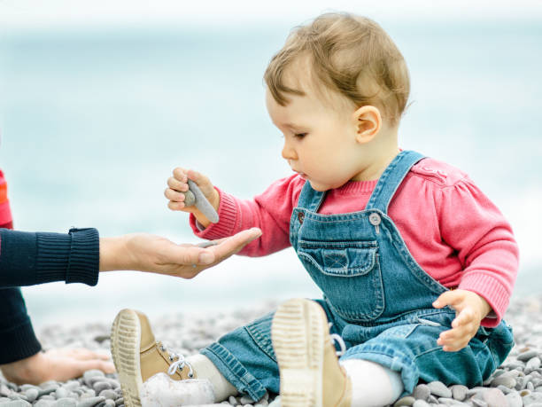 istock Beautiful baby play on the beach 1145518952