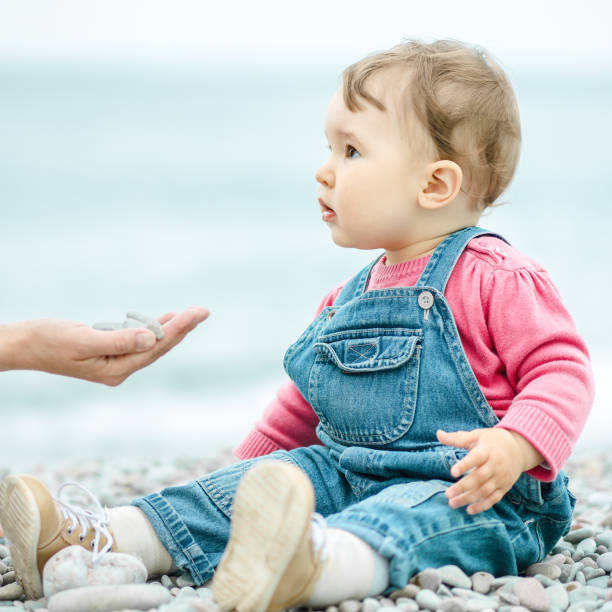 istock One-year-old child on the beach in spring 1145518964
