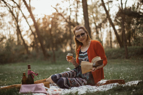 istock Woman in park having a picnic and reading a book 1145519205