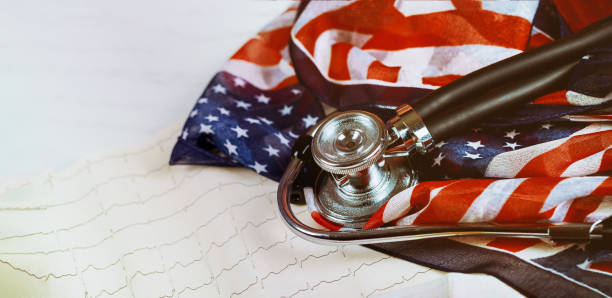 Graphic print of cardiogram measuring heart beats Stethoscope on US flag. Graphic print paper of cardiogram measuring heart beats Stethoscope on US flag. md in usa stock pictures, royalty-free photos & images