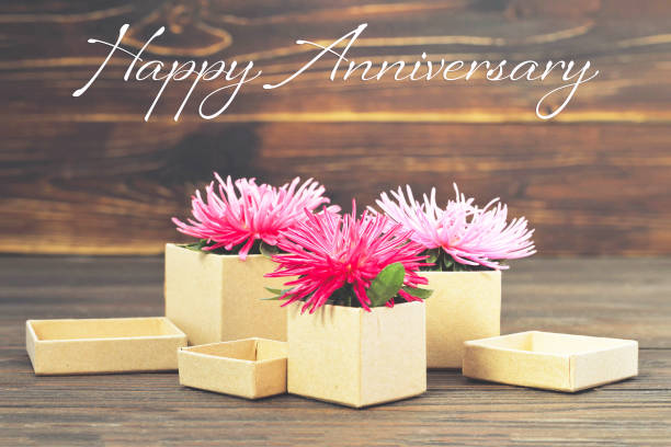 istock Happy Anniversary card with gift boxes and flowers 1145527312