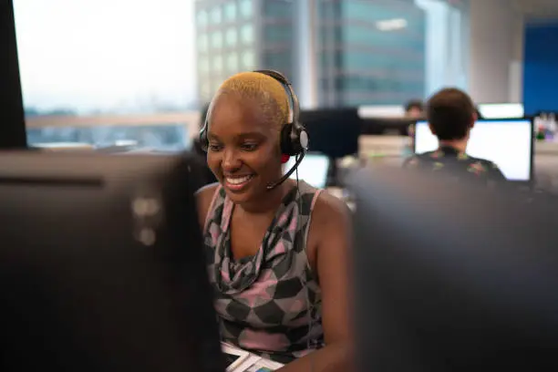 Businesswoman wearing headset in office callcenter