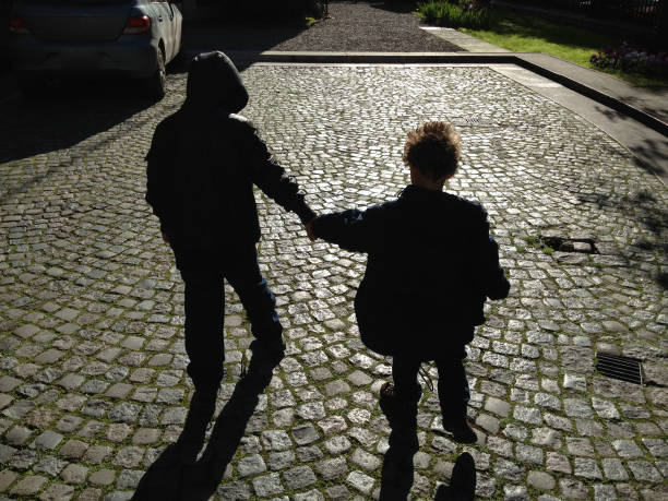 istock Brothers holding hands outdoors 1145532228