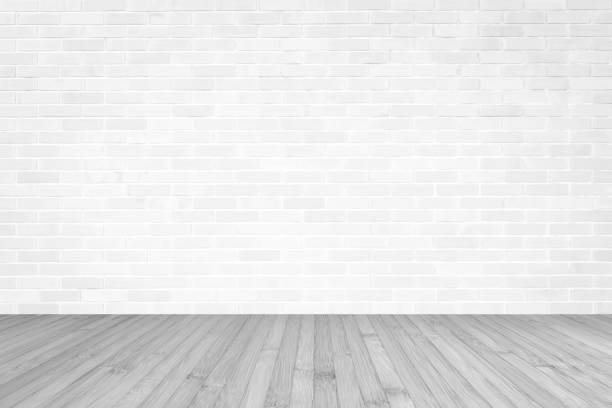 istock White brick wall with wooden floor textured background in light grey color 1145532260
