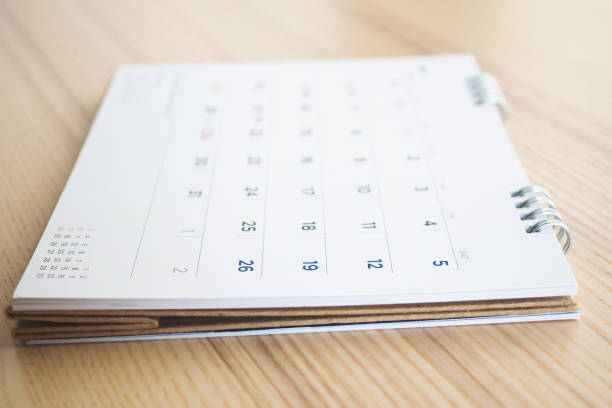 istock calendar page on wood table background 1145532343