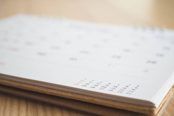 istock calendar page on wood table background 1145532345