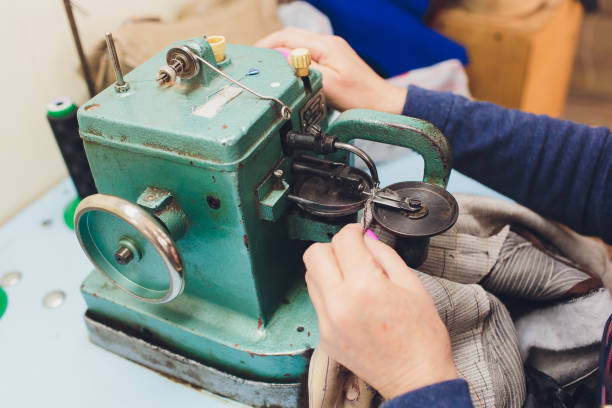 istock Female hands doing maintenance work on a domestic sewing machine. 1145532739