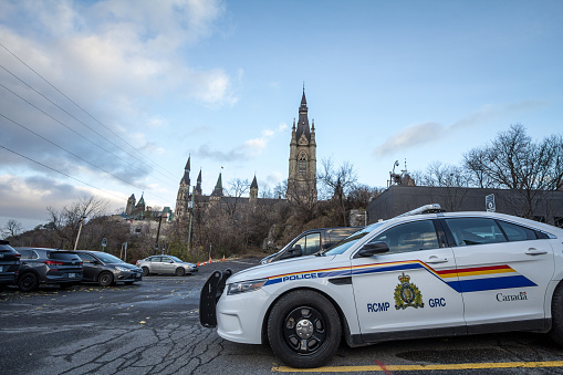 Picture of a car from the RCMP GRC police, parked in front of the Parliament of Canada. Also called Royal Canadian Mounted Police, it is the federal and national police force of Canada. The RCMP provides law enforcement at the federal level.