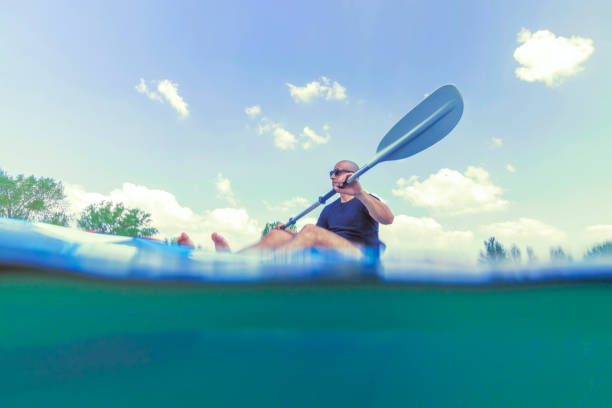 istock Young Man Kayaking on Lake, Kayaking Underwater View, Split Shot. 1145536427
