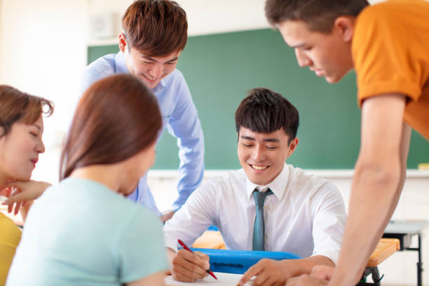 istock teacher with group of college students in classroom 1145550634