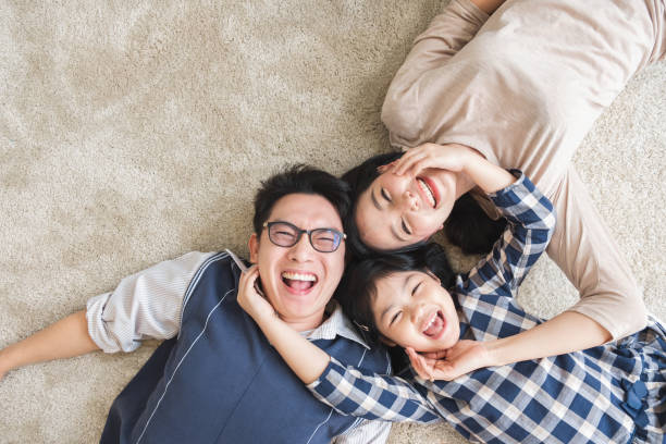 Happy Asian family laying with happy and smile, top view stock photo