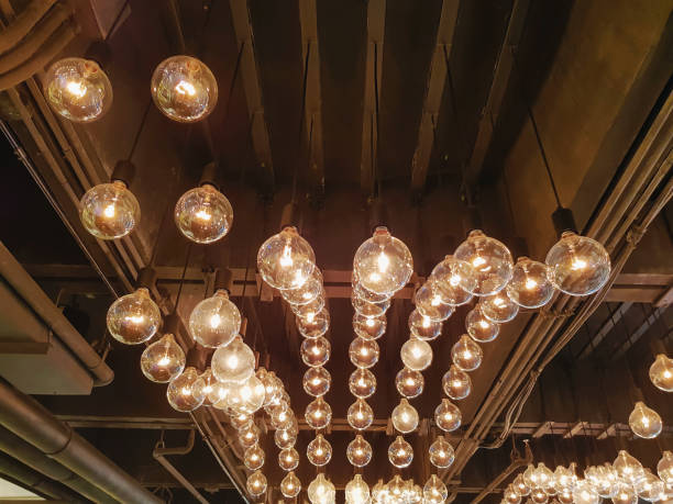 istock Retro Decorative Hanging Illuminated Light Bulbs Inside the Room 1145553890